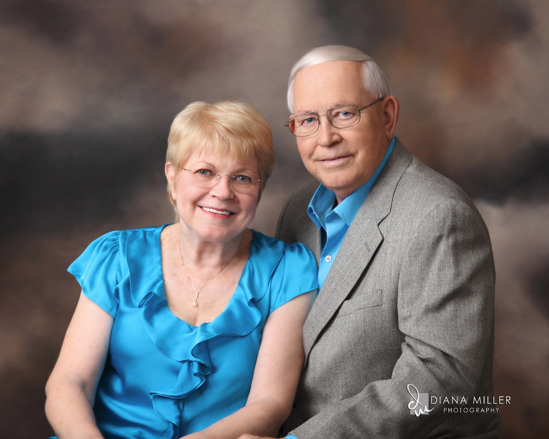 A studio portrait of a senior citizen couple.