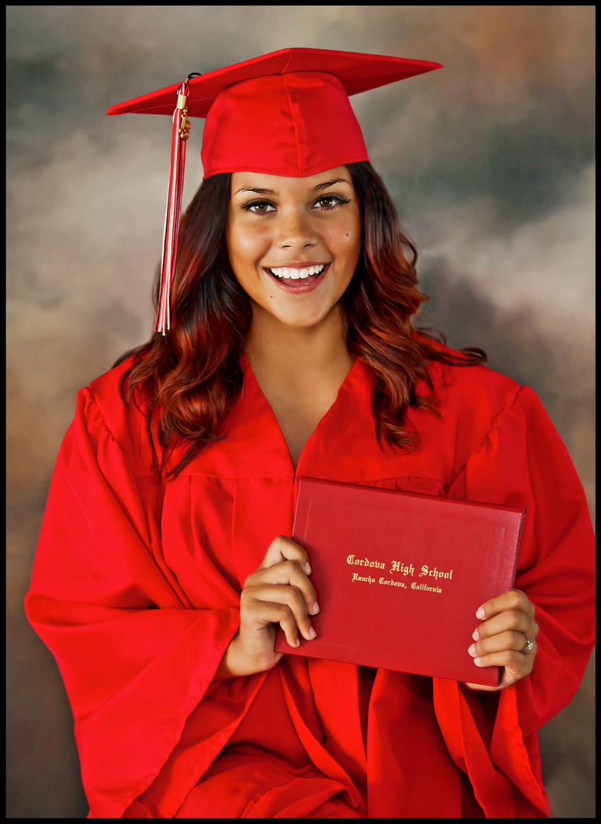 Female HS Graduate in cap and gown with diploma