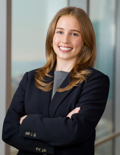 Business portrait of young woman by office windows