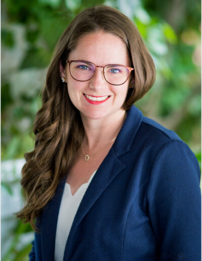 Outside Portrait with greenery of a female with glasses