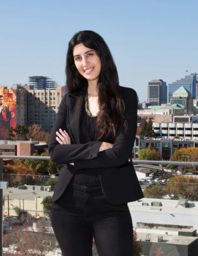 woman in black suit standing on downtown balcony